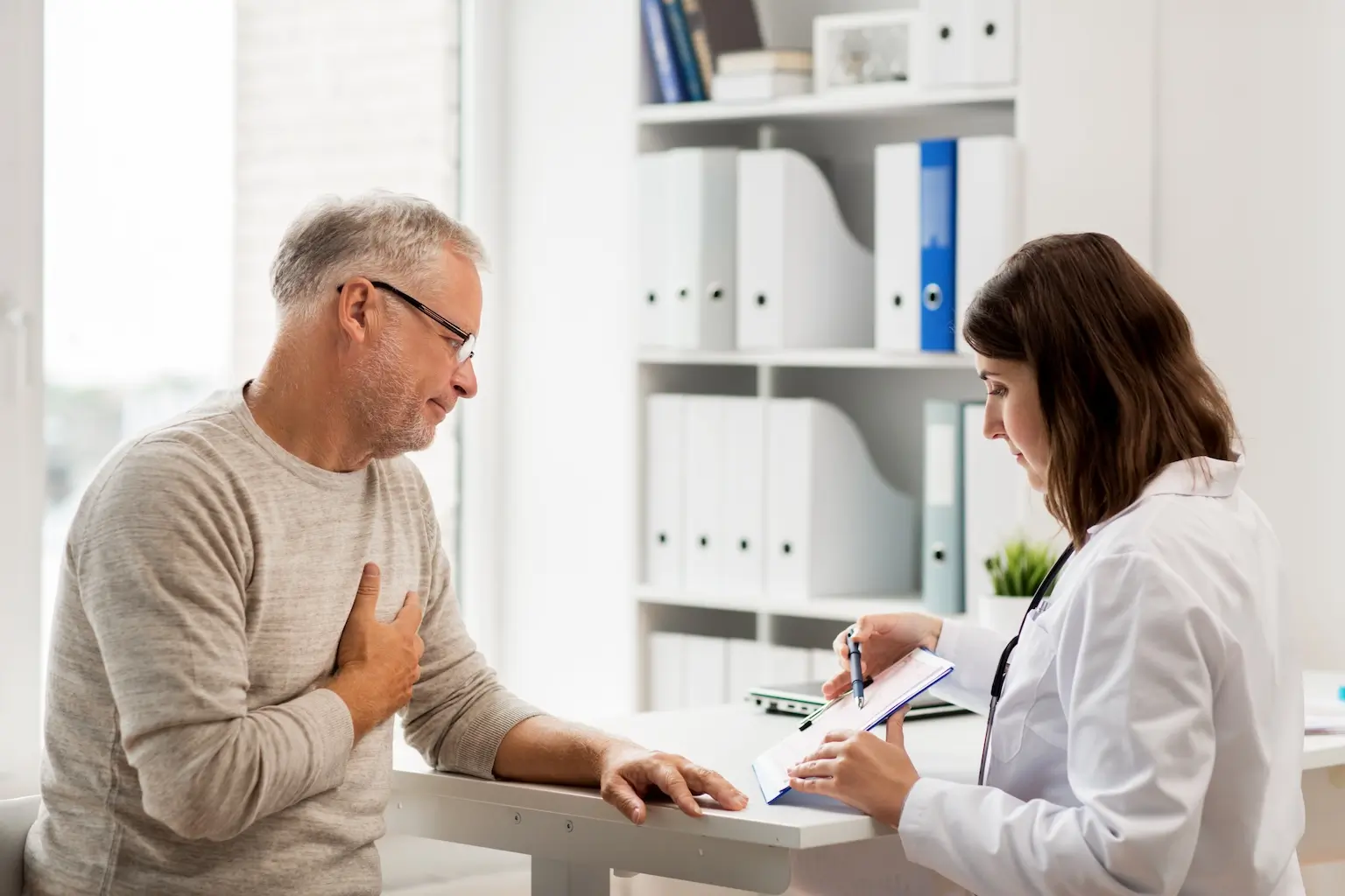 Female doctor talking to a male patient