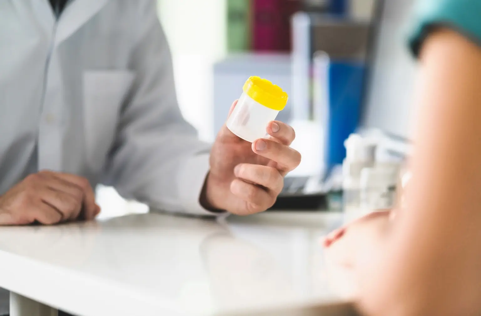 Doctor with a urine sample pot
