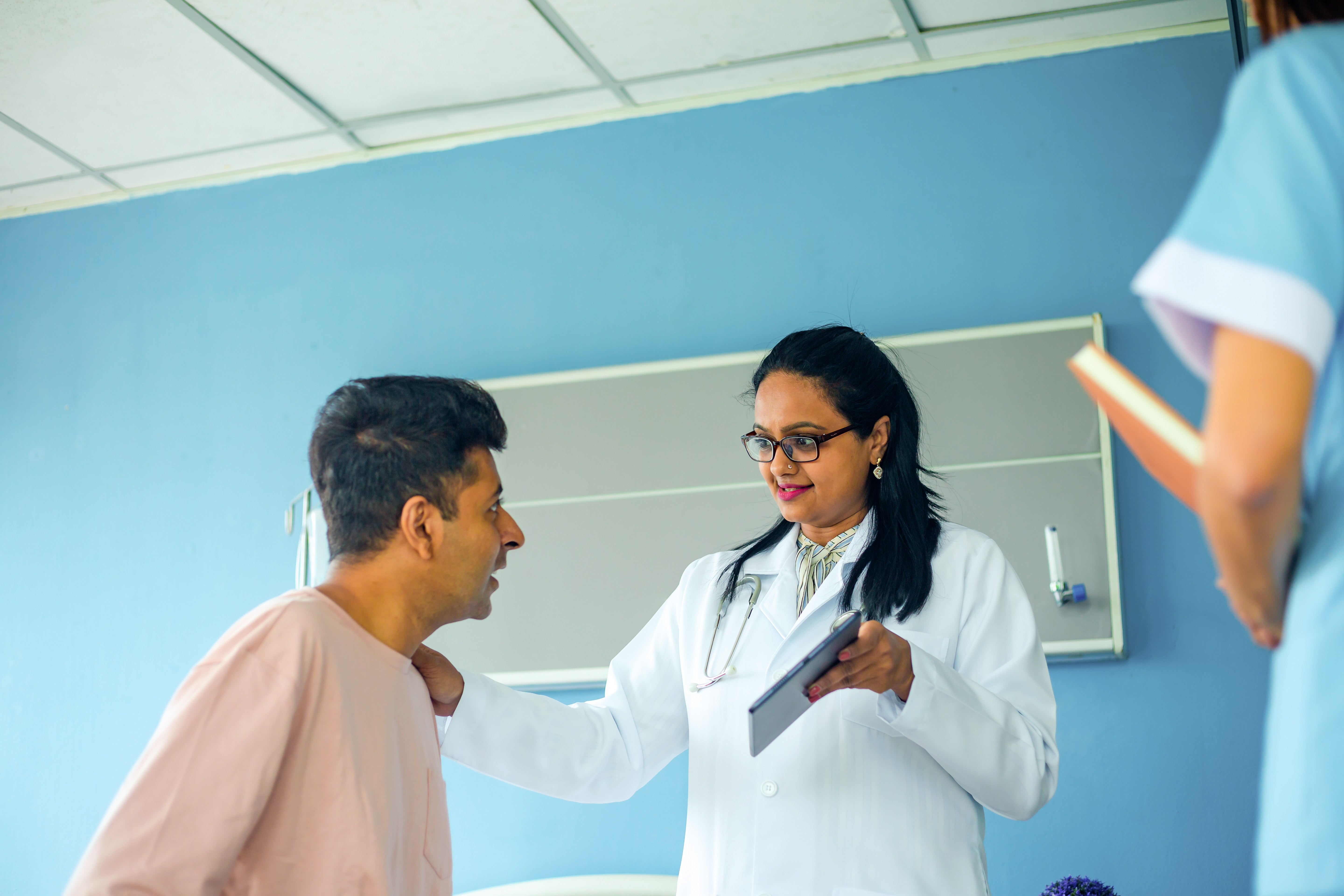 Nurse and doctor with a patient
