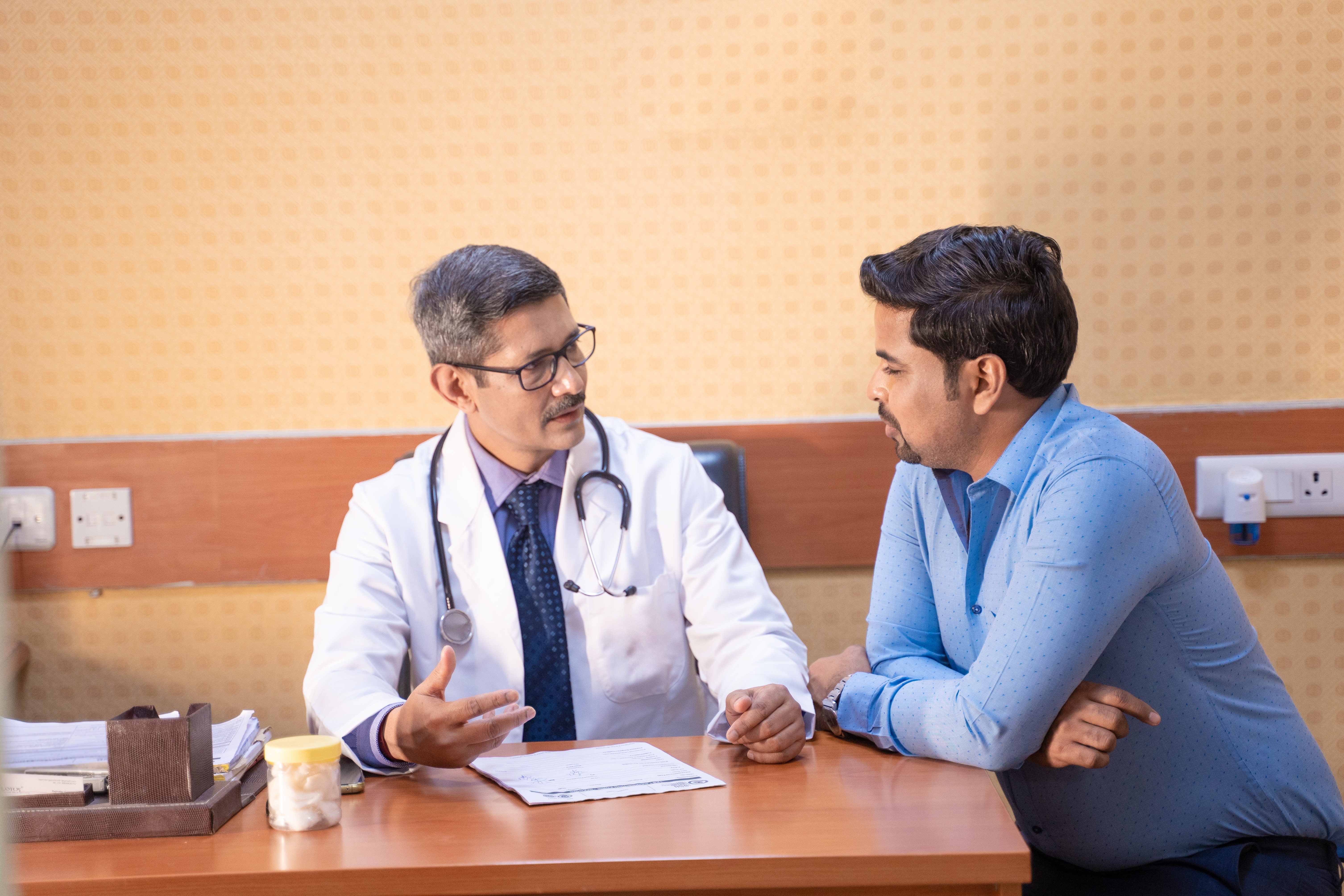 Doctor explaining paperwork to a patient