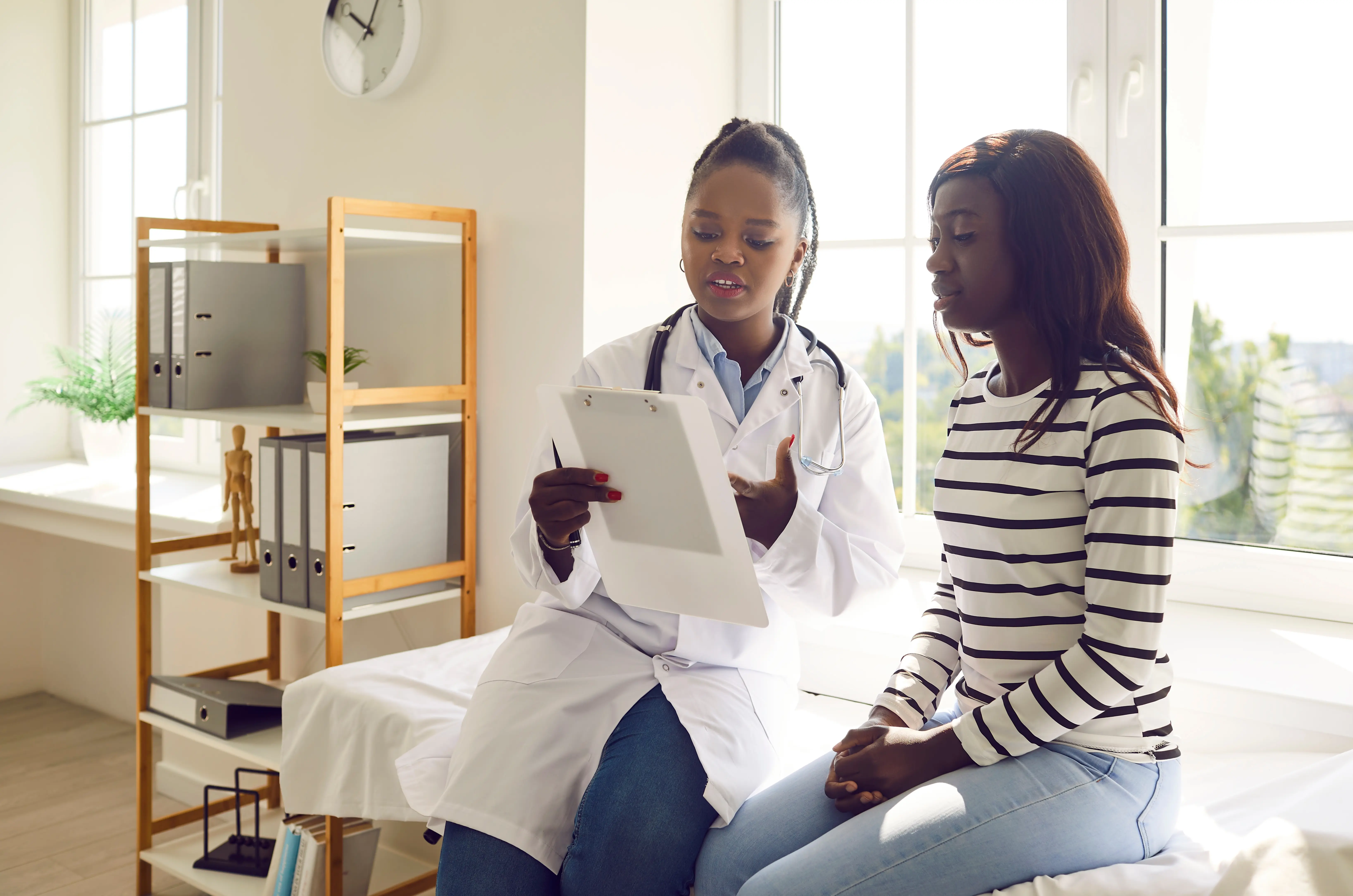 Patient and doctor on consult bed talking